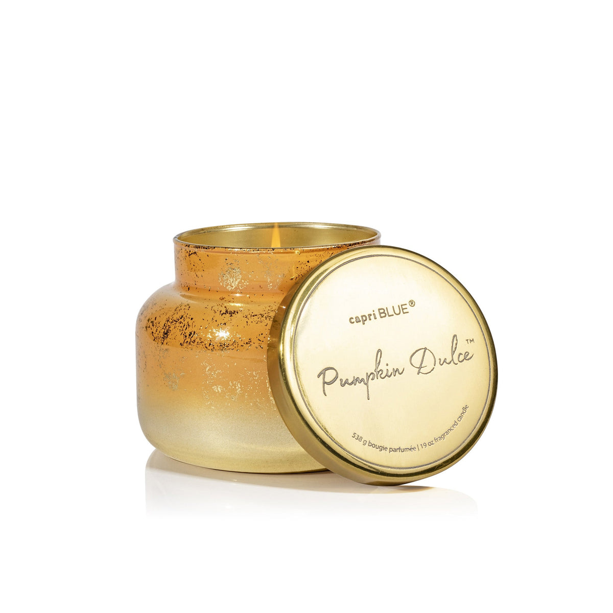 Capri Blue Pumpkin Dulce Glimmer Signature Candle in a shimmering gold jar with its lid off, showing the lit candle.