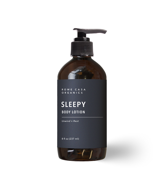 Rowe Casa Organics Sleepy Body Lotion 8 oz in a dark amber pump bottle with black label, for unwind + rest.