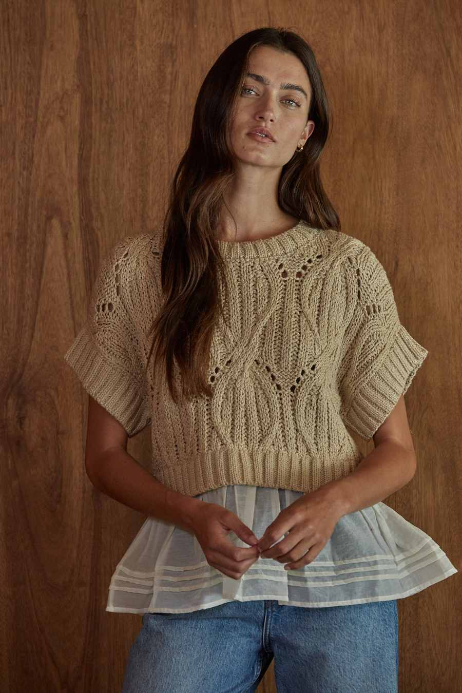 Woman wears Cali Crochet Twofer Top in Taupe Cream - By Together, a short-sleeve cable knit and eyelet top with white tiered hem.