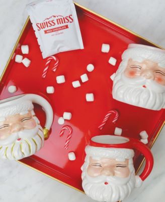 8 Oak Lane Red Santa Coffee Mugs on a festive red tray with Swiss Miss hot chocolate mix, marshmallows, and candy canes.