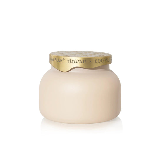 Capri Blue Coconut Santal Terrazza Velluto Candle in a light beige matte jar with a golden lid labeled 'Artisan Coconuts'.