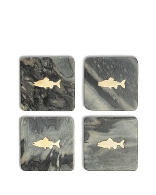 Four The Royal Standard Fish Marble Coasters in black and grey, each with a gold brass fish inlay.