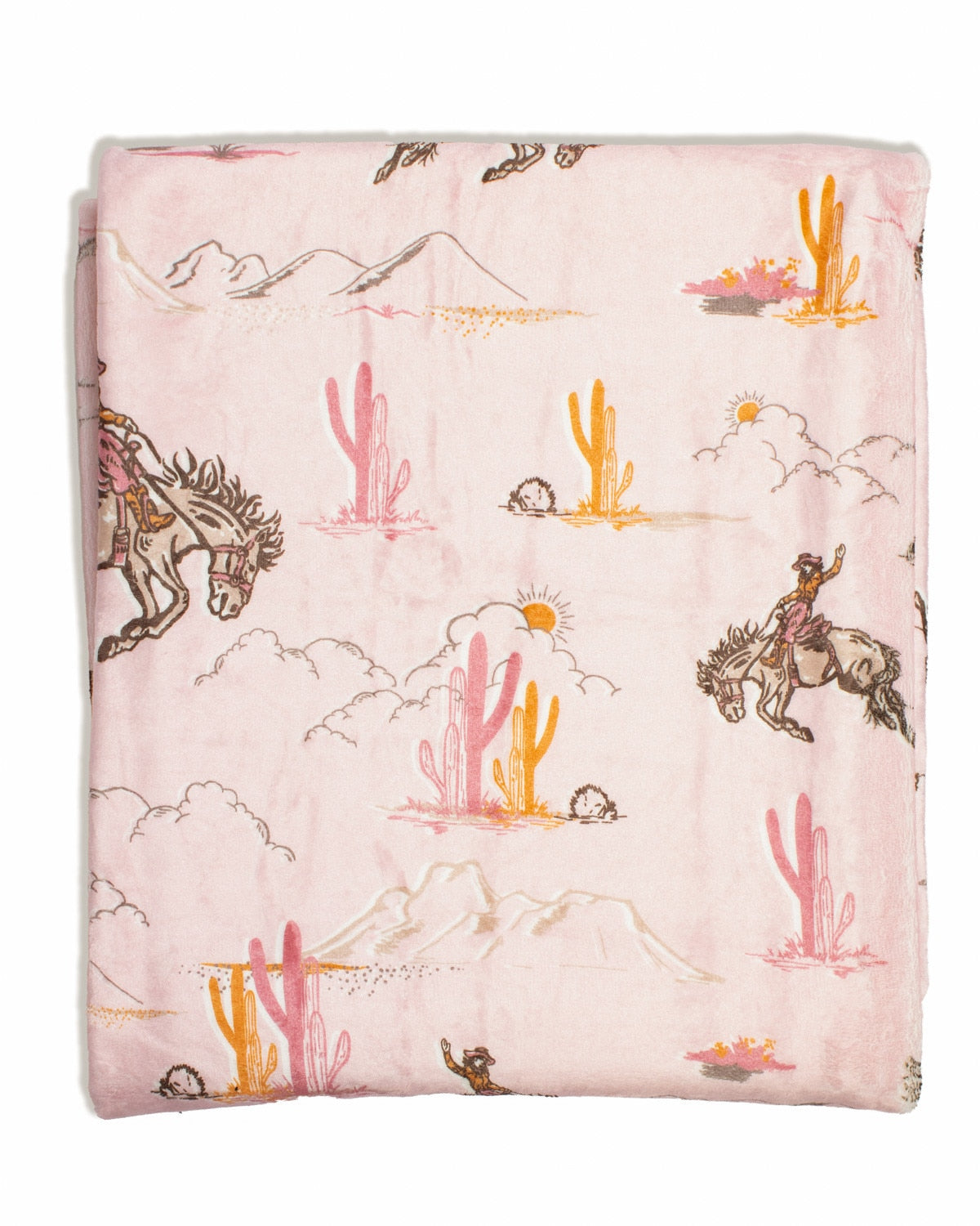 Howdy Hunny Throw in Pink/Multi featuring cowboys on bucking horses, cacti, mountains, and desert landscape